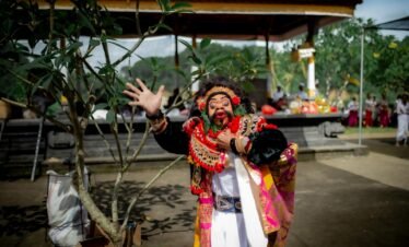 Colorful performance of traditional Balinese Barong dance in Denpasar, showcasing rich cultural attire and expressive movement.