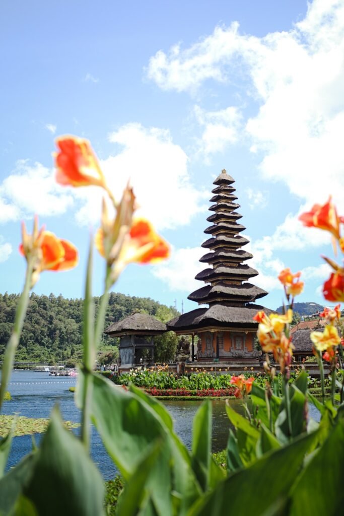 a pagoda in the middle of a field of flowers