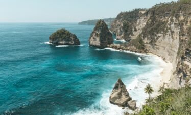 brown rock formation on blue sea water during daytime