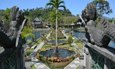 a garden with a fountain surrounded by statues