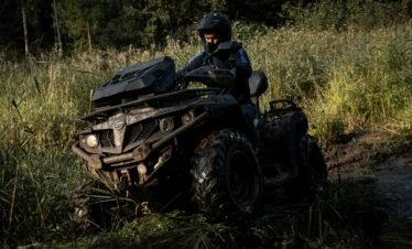 a man riding on the back of an atv