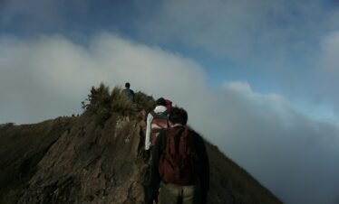 a group of people climbing a mountain