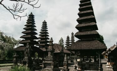 a group of stone structures with trees in the background