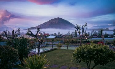 a mountain in the distance with a pool in the foreground