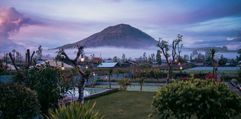 a mountain in the distance with a pool in the foreground