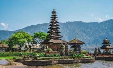 a group of pagodas sitting next to a body of water