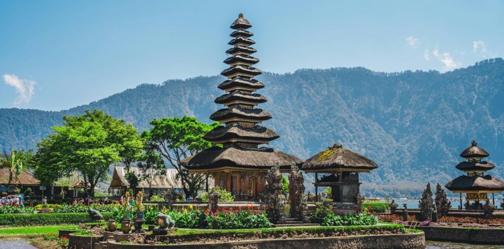 a group of pagodas sitting next to a body of water