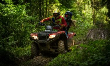 man and woman riding on ATV