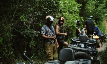 a group of people standing next to motorcycles